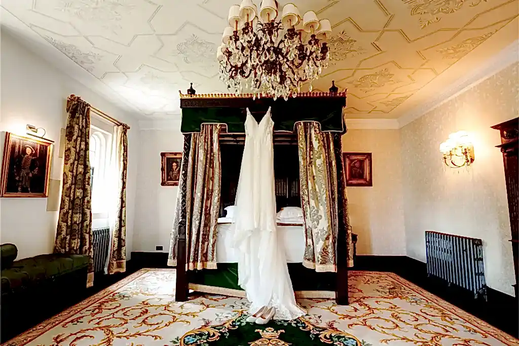tudor castle room with dress hanging on four poster bed