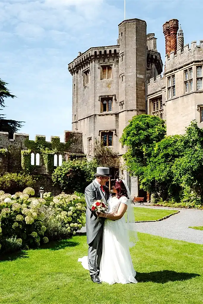 couple pose outside thornbury castle wedding venue