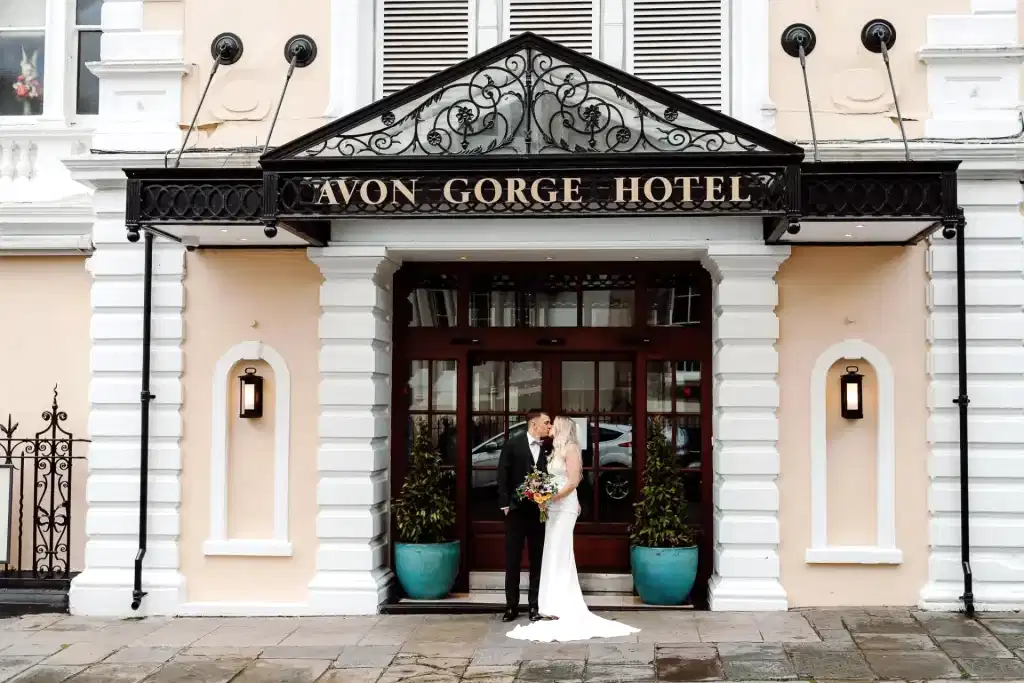 bristol wedding videographer captures couple kissing at front entrance to the Avon Gorge Hotel