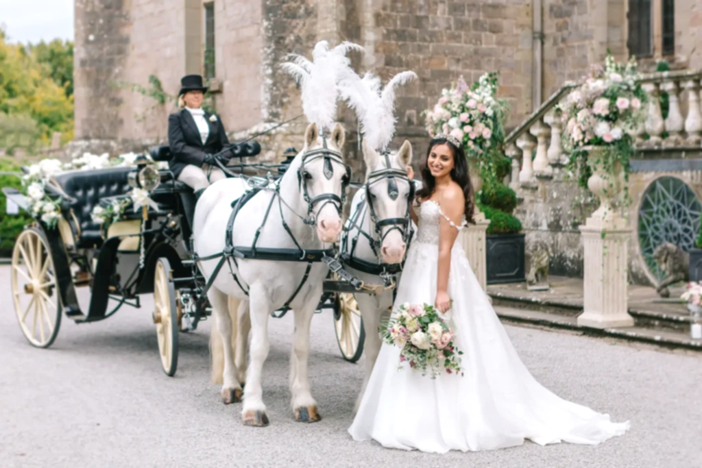 bride poses with horse and carriage outside clearwell castle wedding venue