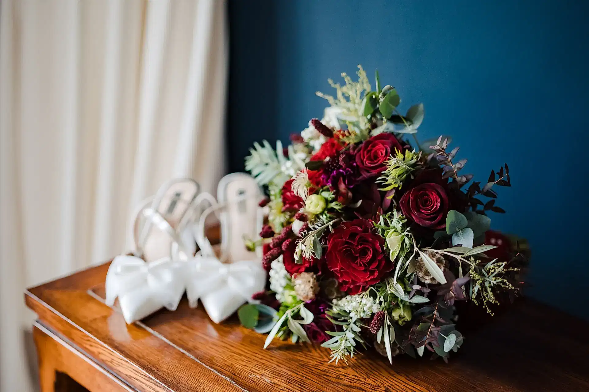 wedding photography portfolio photo of shoes next to flowers