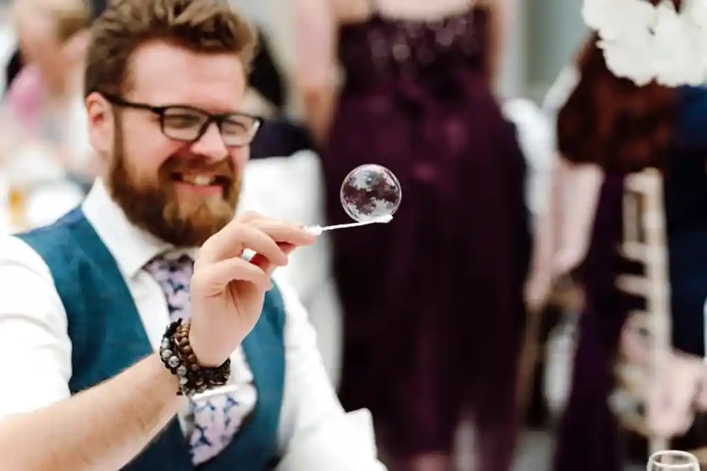 HOR0523-LOWRES-0894 man balances bubble on the end of a bubble wand