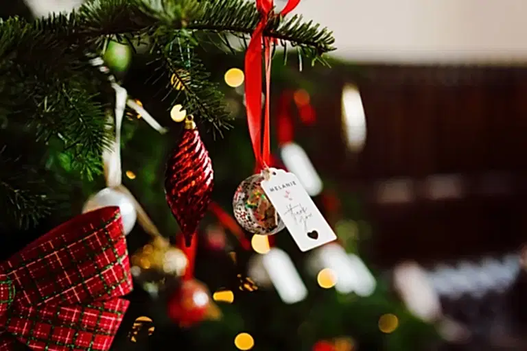 a christmas wedding tree with name tags and baubles for the guests