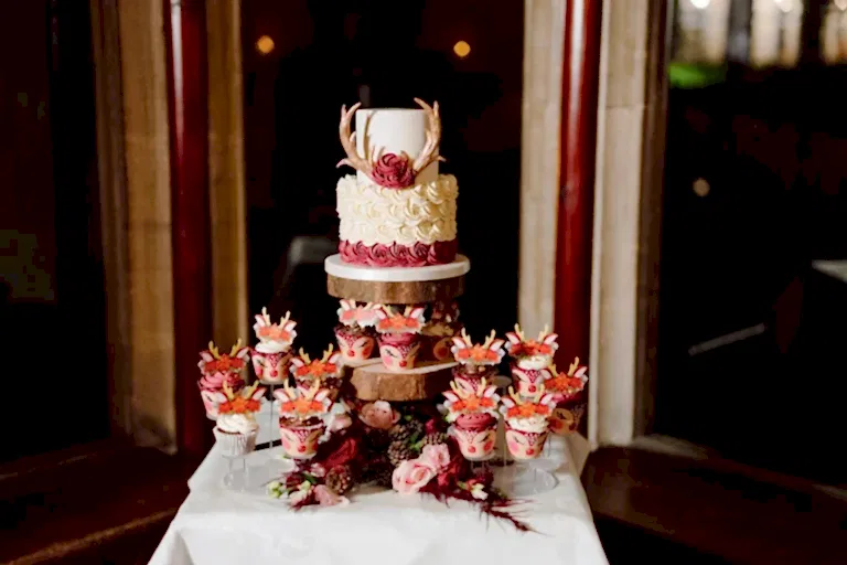 a christmas themed wedding cake with reindeer cupcakes