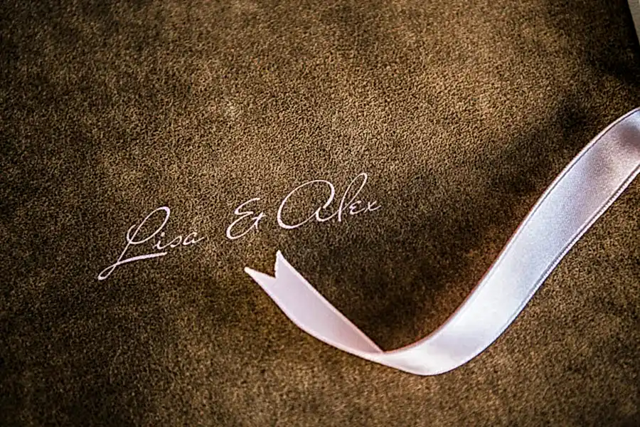 wedding book cover with pink ribbon and names Lisa and Alex