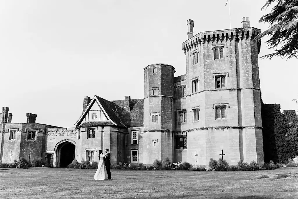 thornbury castle wedding venue with bride and groom dancing on the lawn in front of it