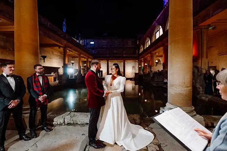 a couple exchange vows while holding hands while demonstrating winter weddings at the Roman Baths