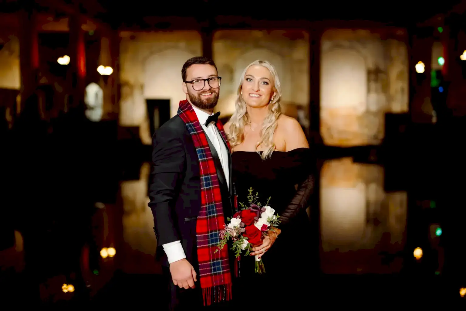 man and woman pose in their winter wedding attire at the roman baths wedding venue