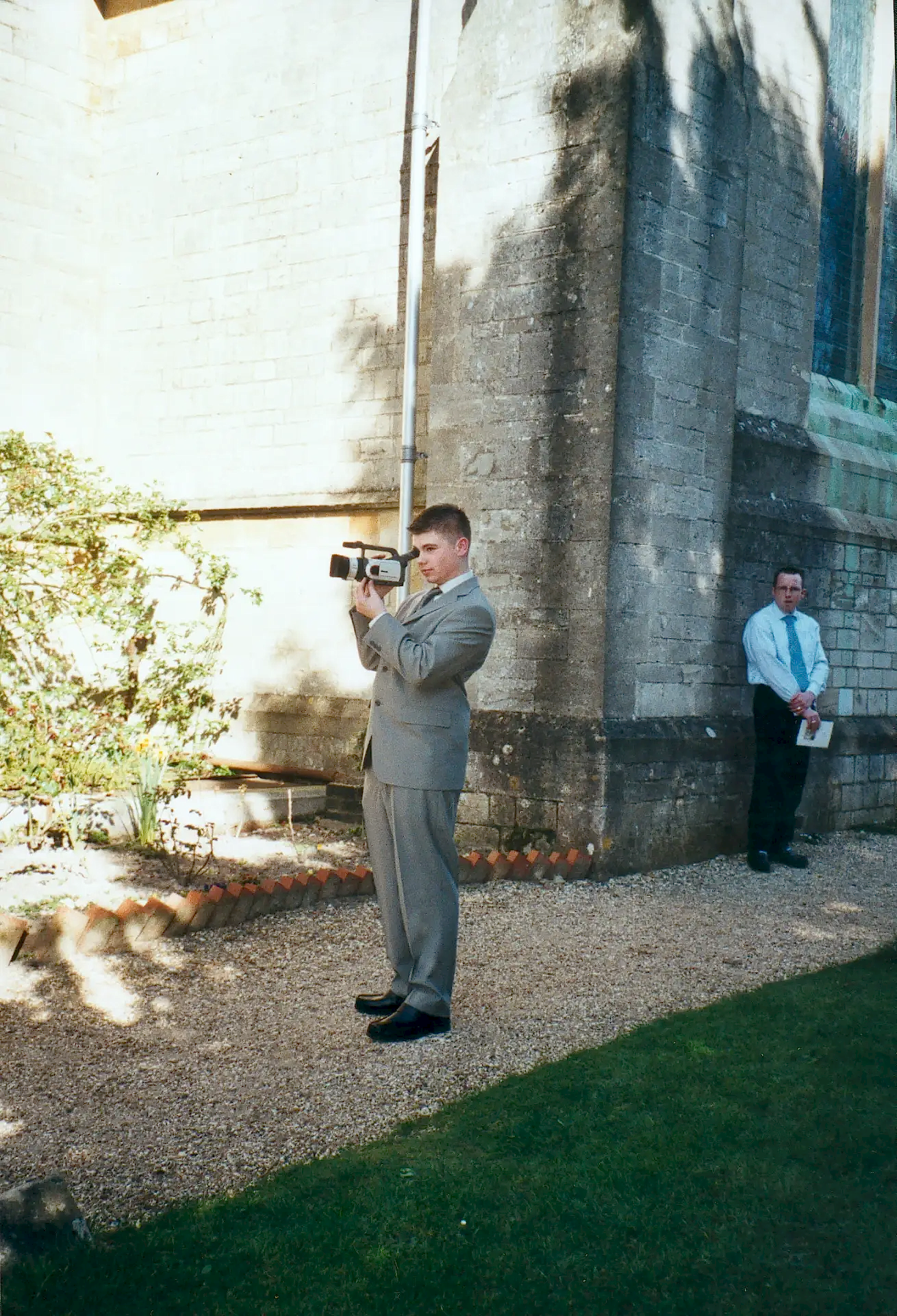 sam from white villa holding a canon mini dv camcorder at his first professional wedding in 2003 in this about us photo