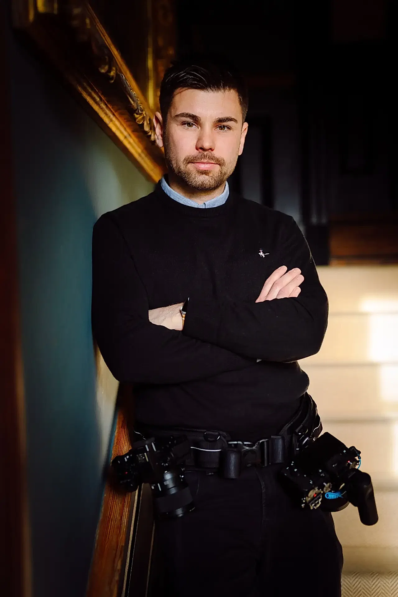 about white villa photo showing sam leaning against wall with arms folded in this profile picture