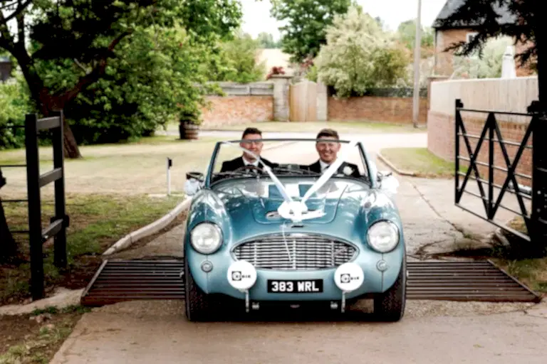 two men in a convertible car