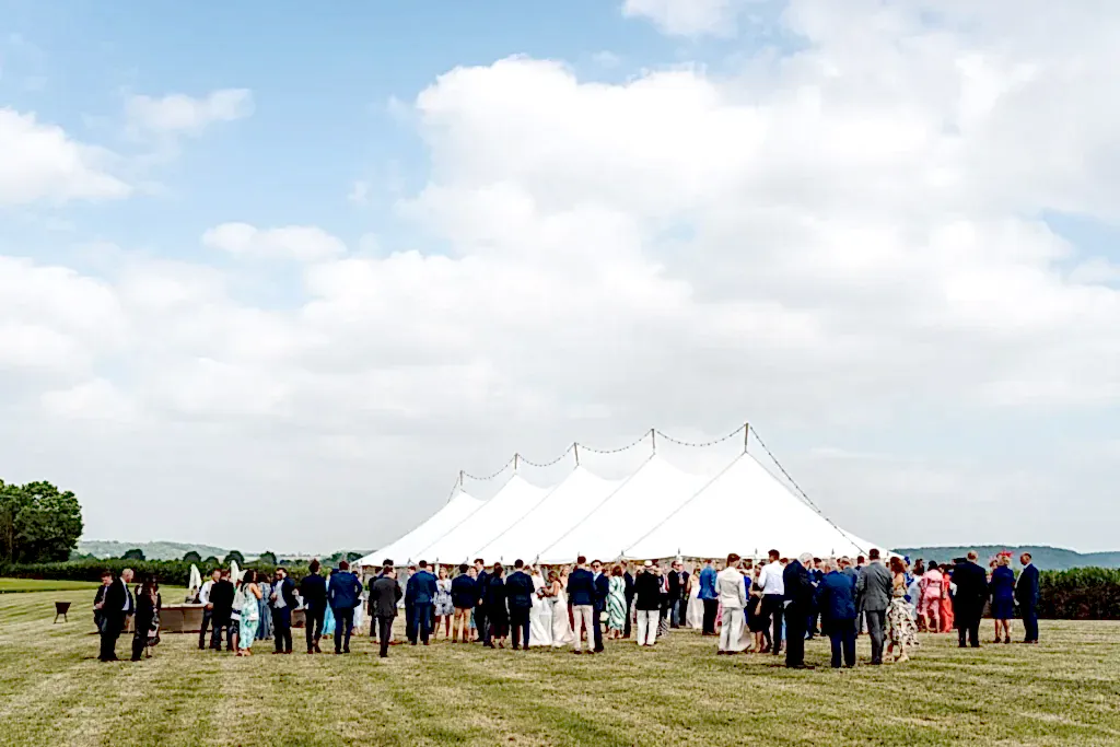 SNO0723-LOWRES-0544 a marquee surrounded by wedding guests at a somerset wedding