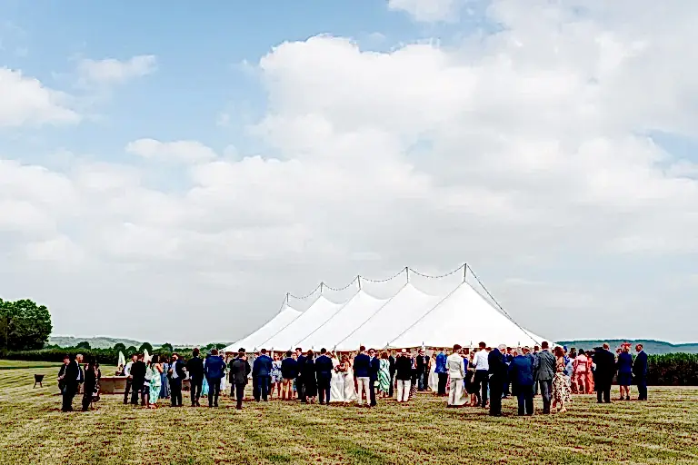 a marquee surrounded by wedding guests at a somerset wedding