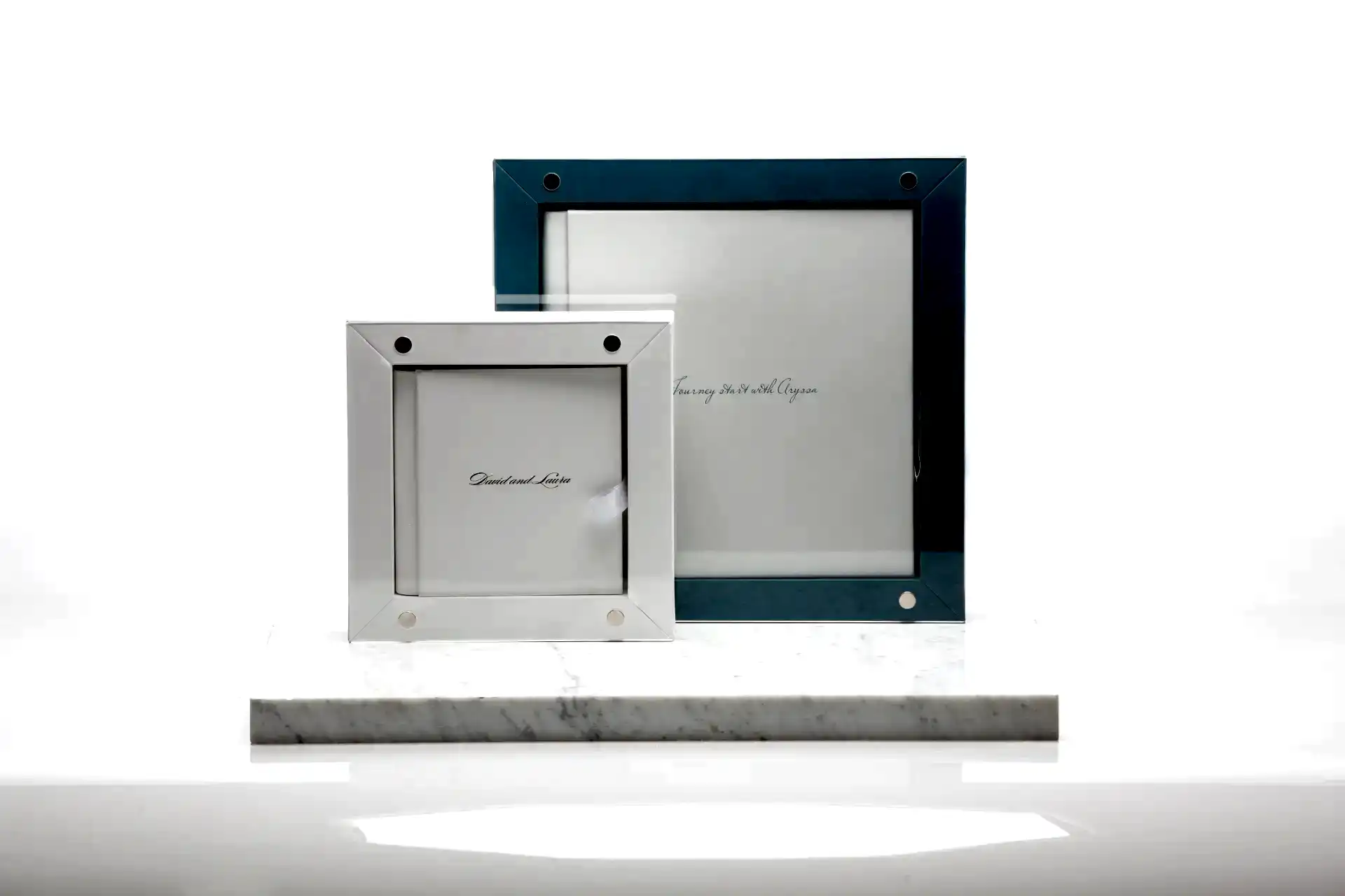 a white and blue picture frame on a marble surface