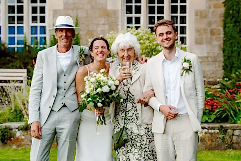 bride and groom pose with their two other family members for their wedding photography
