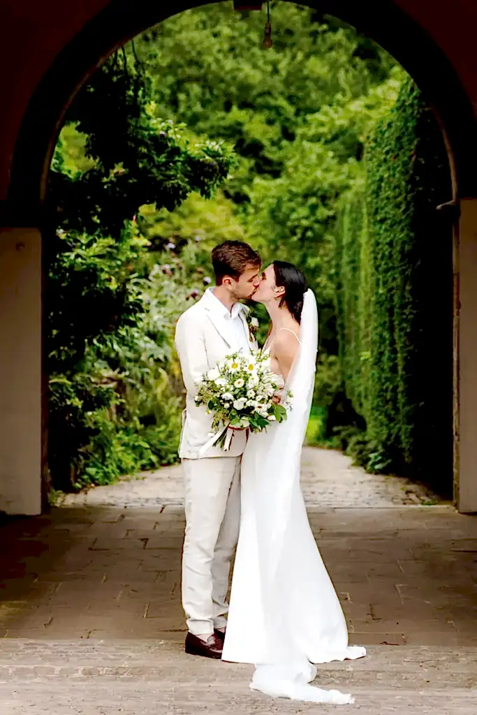 WAR0823-LOWRES-1021 a bride and groom embrace and kiss for their cotswold wedding photographer