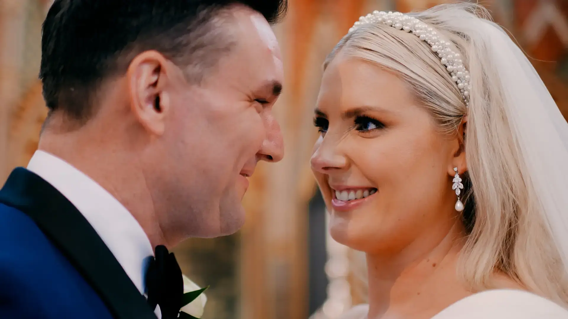 bride looks lovingly into her groom's eyes inside bristol cathedral in this bristol wedding videography photo