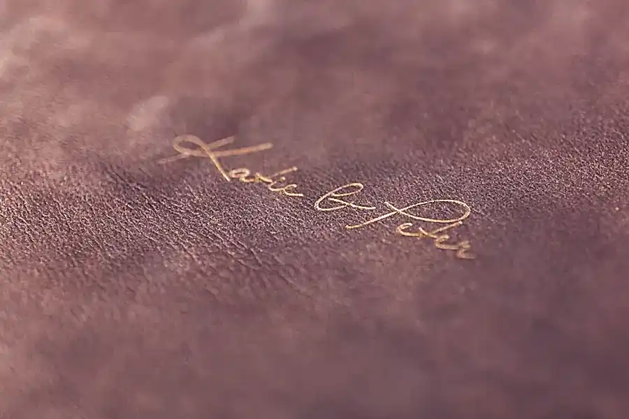 embossed leather logo detail of front of album