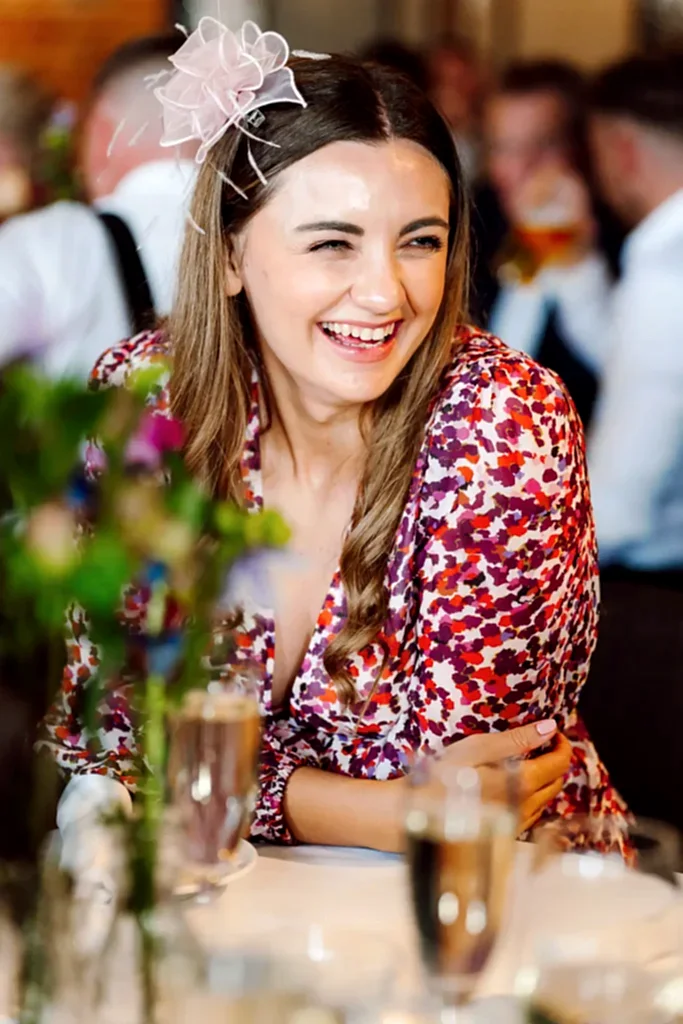 woman-laughs-avon-gorge-hotel-bristol a woman smiling at the camera while sat at a wedding table at the avon gorge hotel
